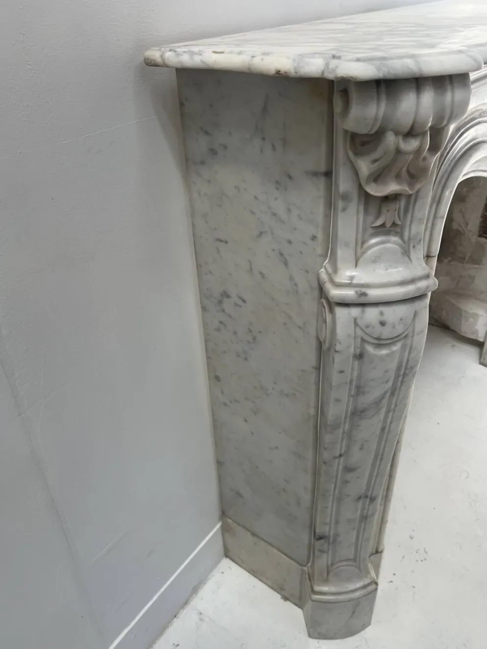 Cheminée de style Louis XV en marbre blanc veiné de Carrare XIX siècle