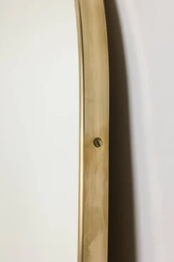 Miroir cerclé de laiton doré. 1980