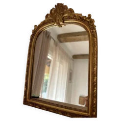 Miroir décoratif avec moulures et fronton.