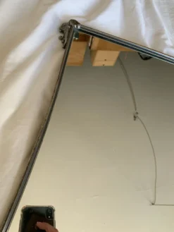 Miroir en metal argenté bord incurvé