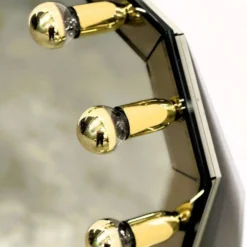 Miroir fumé en laiton allemand vintage avec un dessus architectural facetté, années 1980.