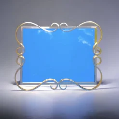 Miroir Hollywood Regency biseauté en aluminium anodisé doré