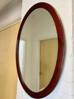 Miroir mural ovale en acajou ancien