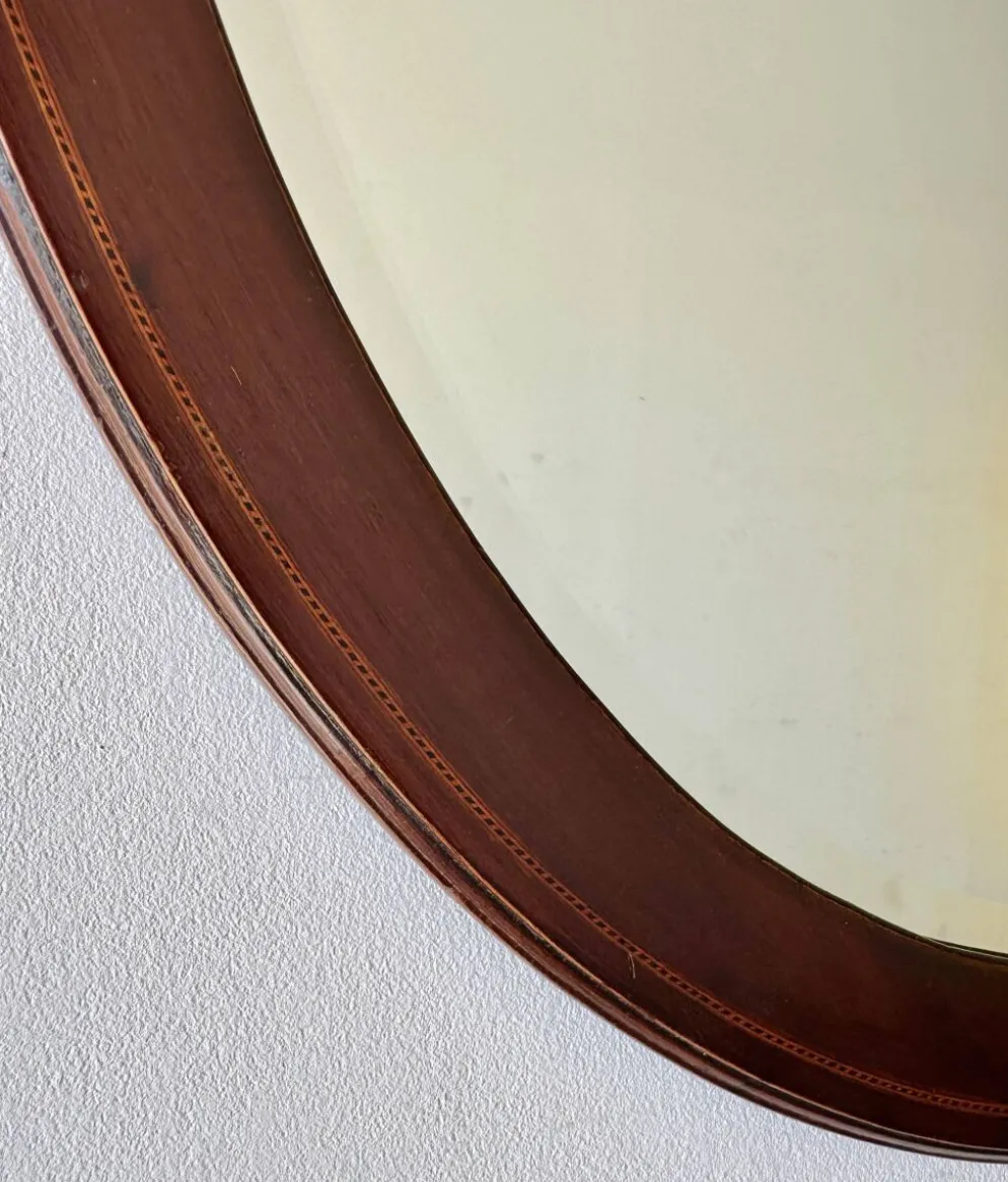 Miroir mural ovale en acajou ancien