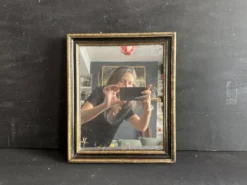 Miroir Napoléon III en bois noir et doré, XIXe siècle