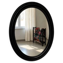 Miroir ovale ancien en bois patiné noir