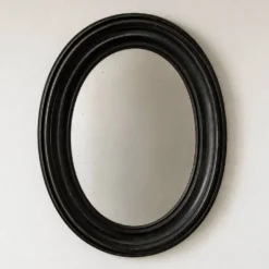 Miroir ovale ancien en bois patiné noir