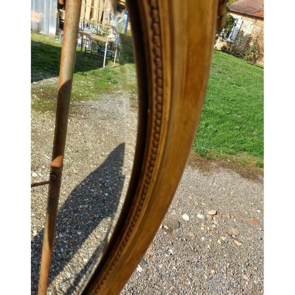 Miroir ovale en bois et stuc doré 19ème