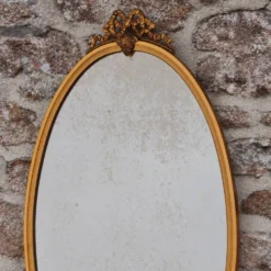 Miroir ovale vintage en métal doré à nœud – style Louis XVI / romantique