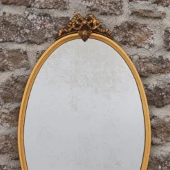 Miroir ovale vintage en métal doré à nœud – style Louis XVI / romantique