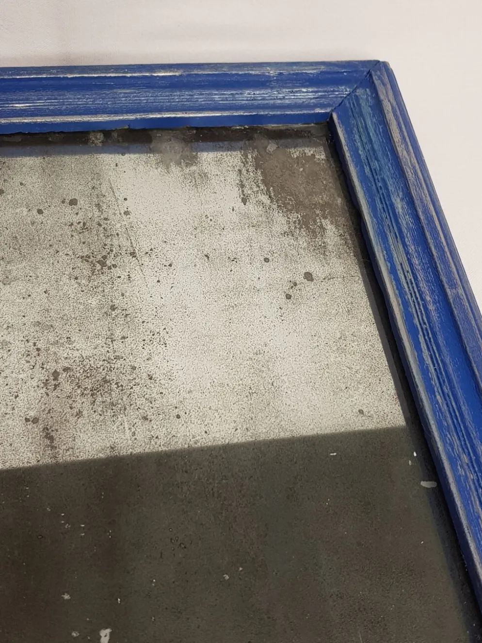 Miroir rectangulaire patine bleu et argent 28 X 46 cm