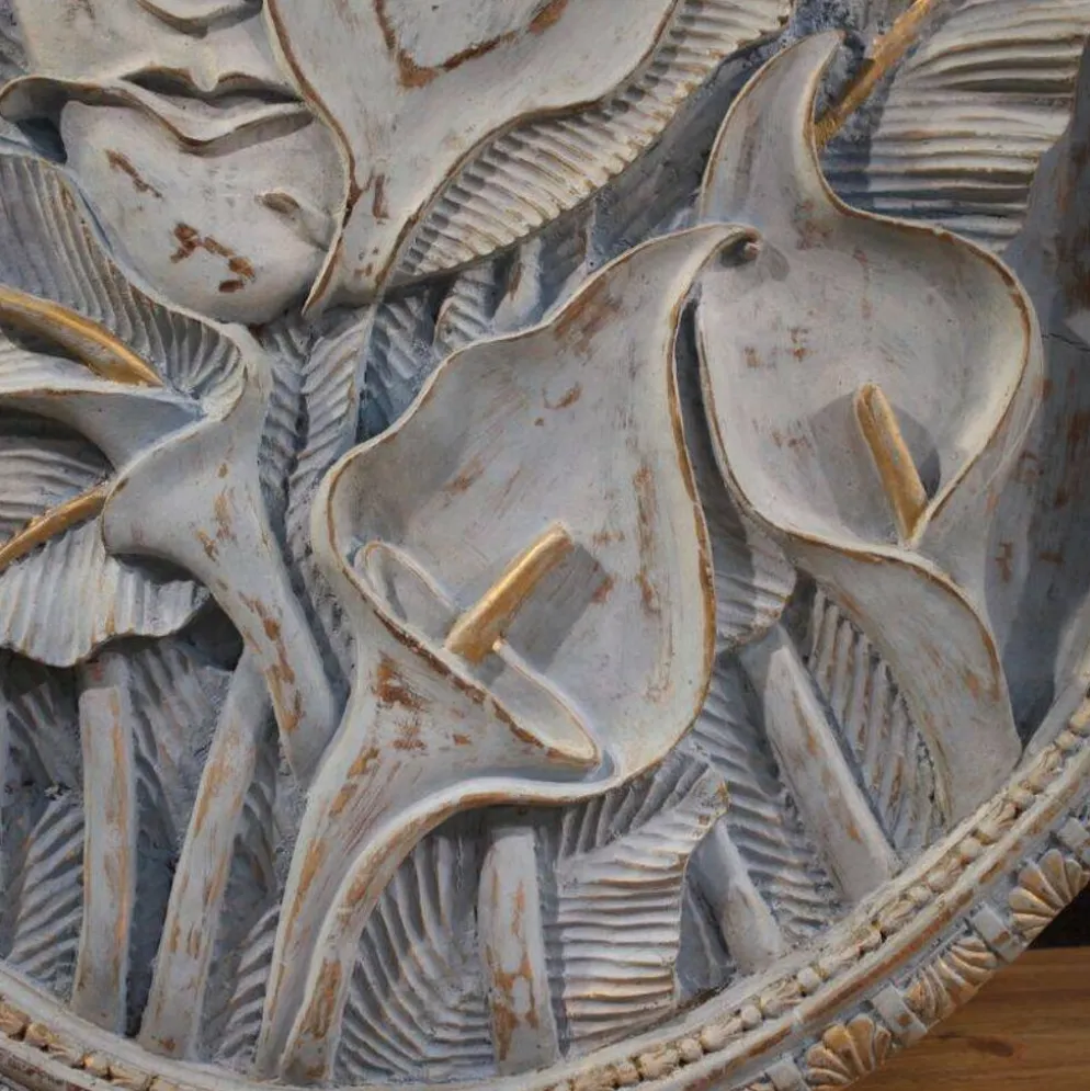 Sculpture en bas-relief, visage stylisé avec des fleurs, 20e siècle