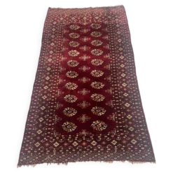 Tapis anciens en laine a décors sur fond rouge XX siècle