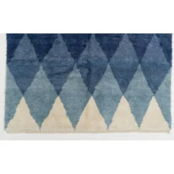 Tapis en laine contemporain avec des diamants bleus entrelacés.