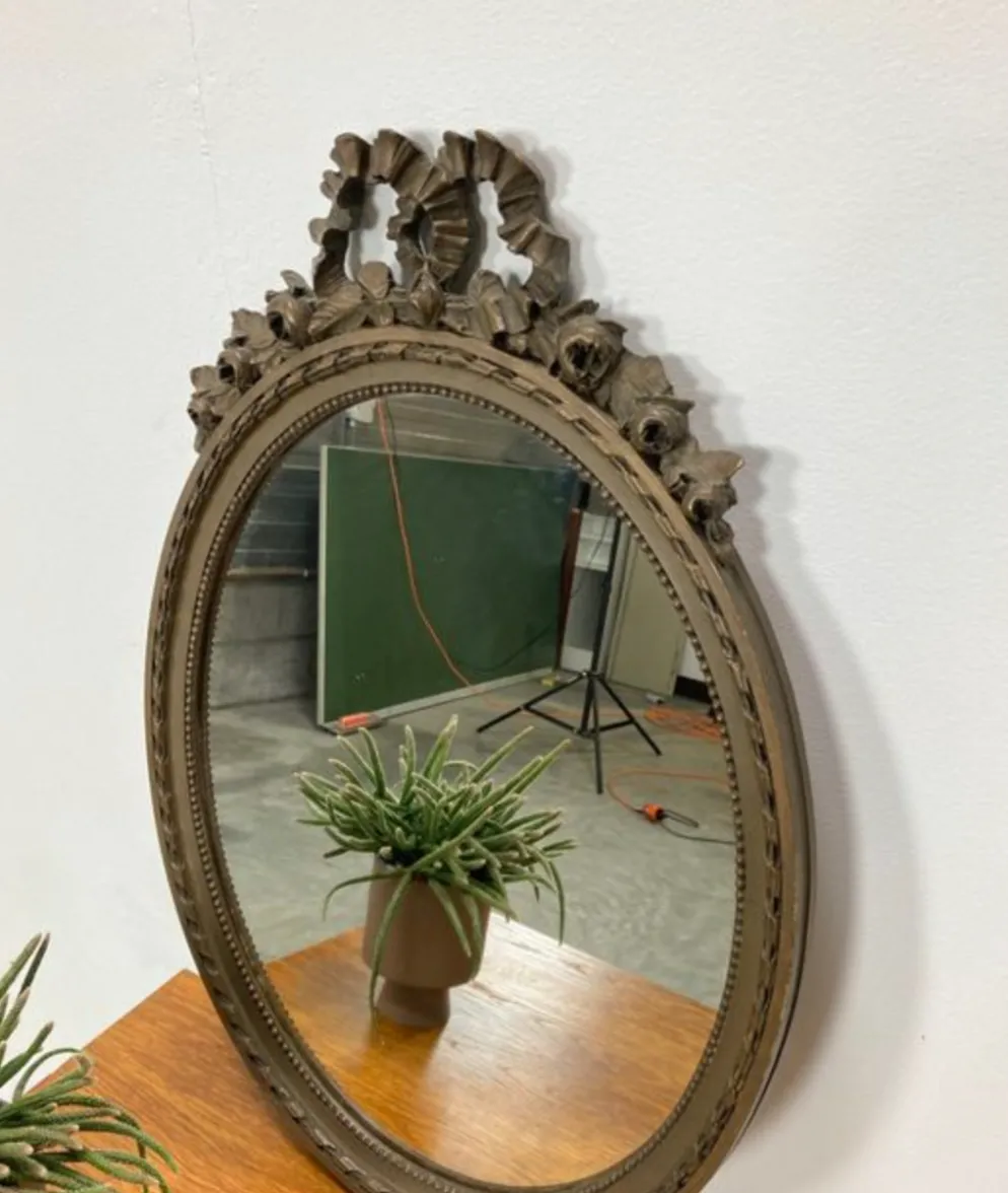 Vintage wooden mirror with arch and flowers
